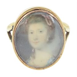 19th century gold portrait ring, set with an oval miniature of a woman wearing a pearl hai...