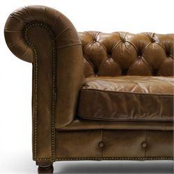 Timothy Oulton for HALO - Three seater brown leather chesterfield sofa, with button back and arms, with two loose cushions, raised on a dark stained supports terminating in castors 
