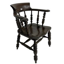 Early 20th century stained beech captains smokers bow chair, spindle tub shaped back over saddle seat, raised on turned supports united by double H-stretcher