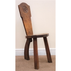  Gnomeman oak milking stool by Thomas Whittaker of Littlebeck, solid shaped back with carved rose, three supports, W32cm  