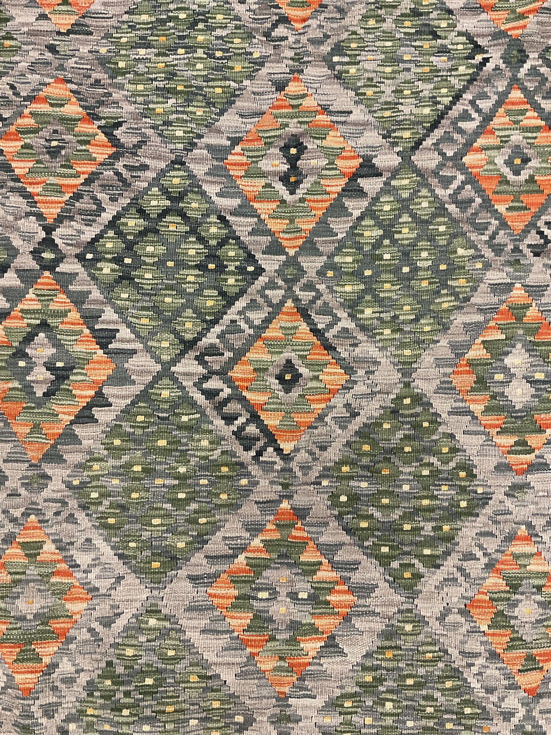 Kilim grey and green ground rug, overall geometric design decorated with lozenges