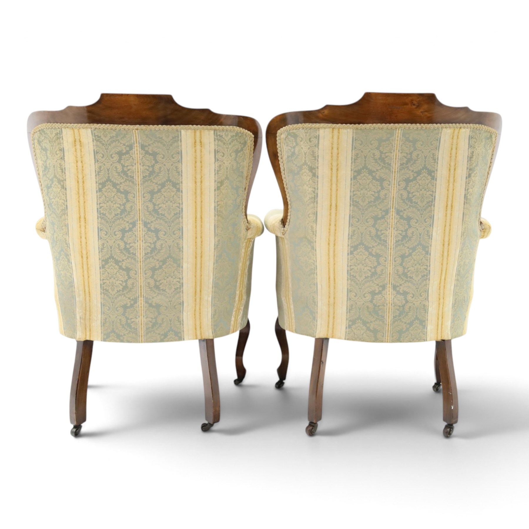 Edwardian mahogany three-piece salon suite, comprising settee and two armchairs, shaped frames with upholstered backs, scrolled arm supports and serpentine seat rails, upholstered in striped floral damask fabric, on cabriole supports with castors (Armchairs: H 96cm, W 70cm, D 68cm)