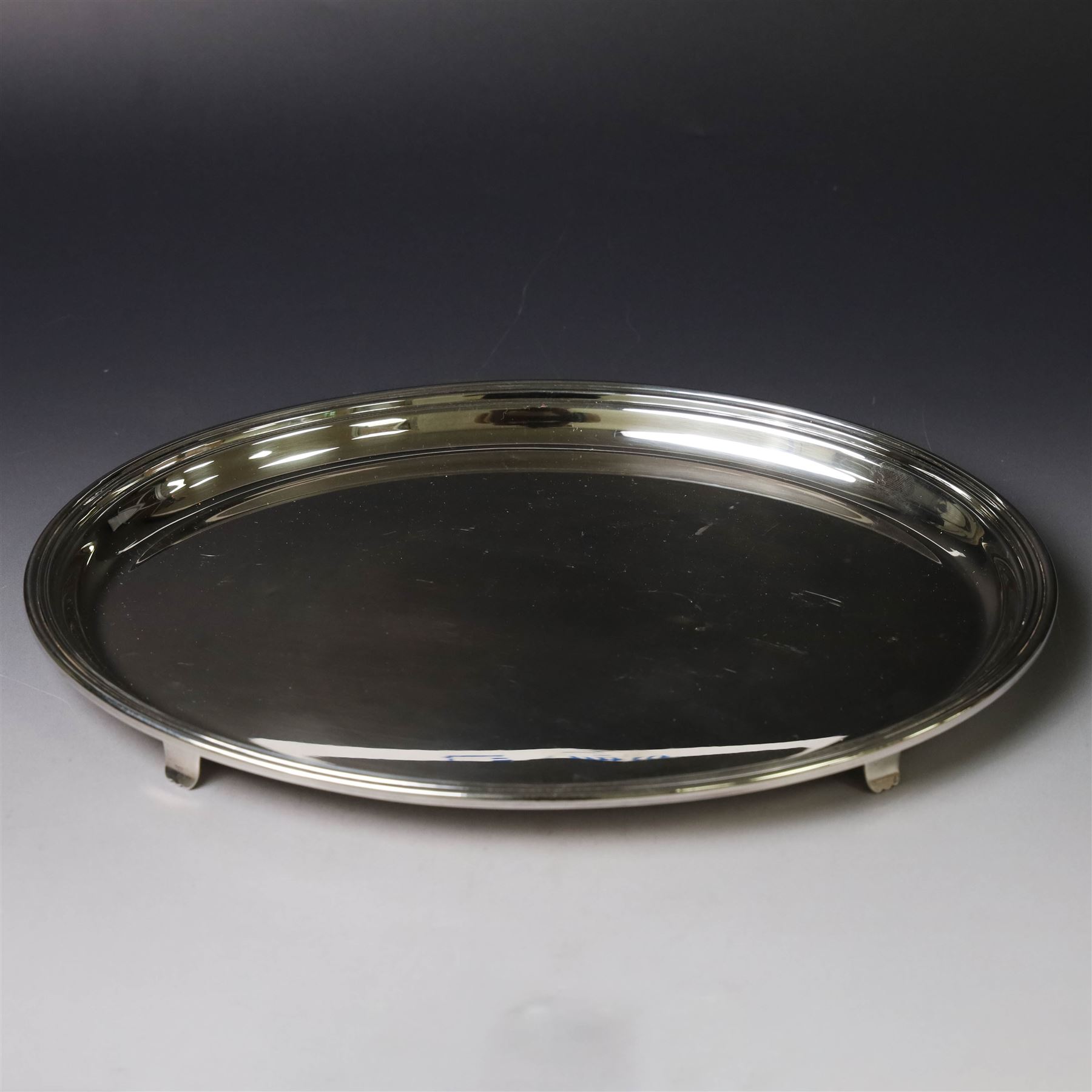 Modern silver tray, of oval form with stepped rim and upon four pad feet, hallmarked Victorian Silverware Ltd, Birmingham 2000, W28.5cm