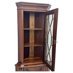 Late 20th century mahogany corner cabinet, dentil moulded cornice above a glazed door with astragal glazing enclosing two shelves, lower cupboard with fielded panel door and turned shell motif, on plinth base
