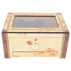 Cigar humidor, of high gloss birdseye maple veneer, the lid with central glass panel, brass handled draw to the front, fitted with a hygrometer, H18cm D24cm 