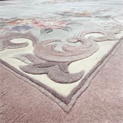 Chinese Aubusson-style jade green wool rug, with a floral medallion and floral corner sprays with a scrolling acanthus and ribbon border in tones of teal, cream, pink, mauve, and cotton fringe ends