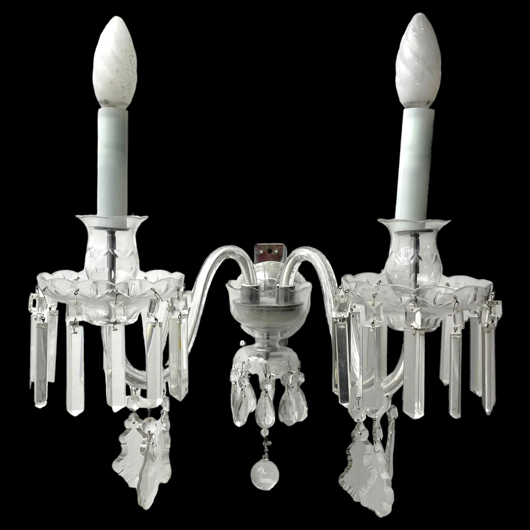 Pair of cut glass two branch wall sconce candelabras, each with S scroll extending branches with shaped and bevelled circular drip trays, hung with pendant drops