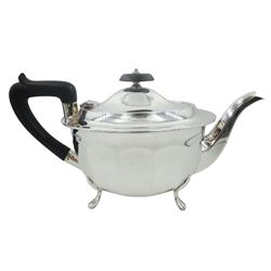 Mid 20th century silver three piece tea service, comprising teapot with ebonised handle and finial, twin handled sucrier, and milk jug, each of oval form with part panelled bodies, upon four paw feet, hallmarked Viner's Ltd, Sheffield 1946, approximate total gross weight 29.28 ozt (911 grams)