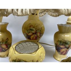 Collection of Aynsley Orchard Gold pattern wares, comprising lamp base, three jars and covers, six vases or various size and form, large jug, lidded dish, pair of cruets, pair of candlesticks, mug, two pin dishes, lobed dish, tea cup, saucer, size plate, and cake plate, and two further cups and saucers, each cup decorated with central Orchard Gold reserve to the interior against a mottled pink or green ground. 