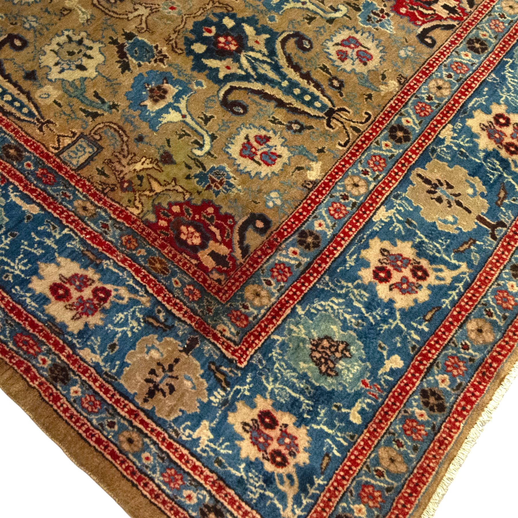 Central-Western Persian Sarouk hand-knotted carpet, beige ground, with an all-over design of boteh and floral sprays in red and blue within a floral border on blue ground 