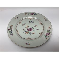 Three 18th century Chinese Famille Rose plates, the first example enamelled with blossoming peonies, rockwork and fence, the other two examples of similar design, decorated with blossoming peonies and sprigs within shaped inner borders, each approximately D23cm
