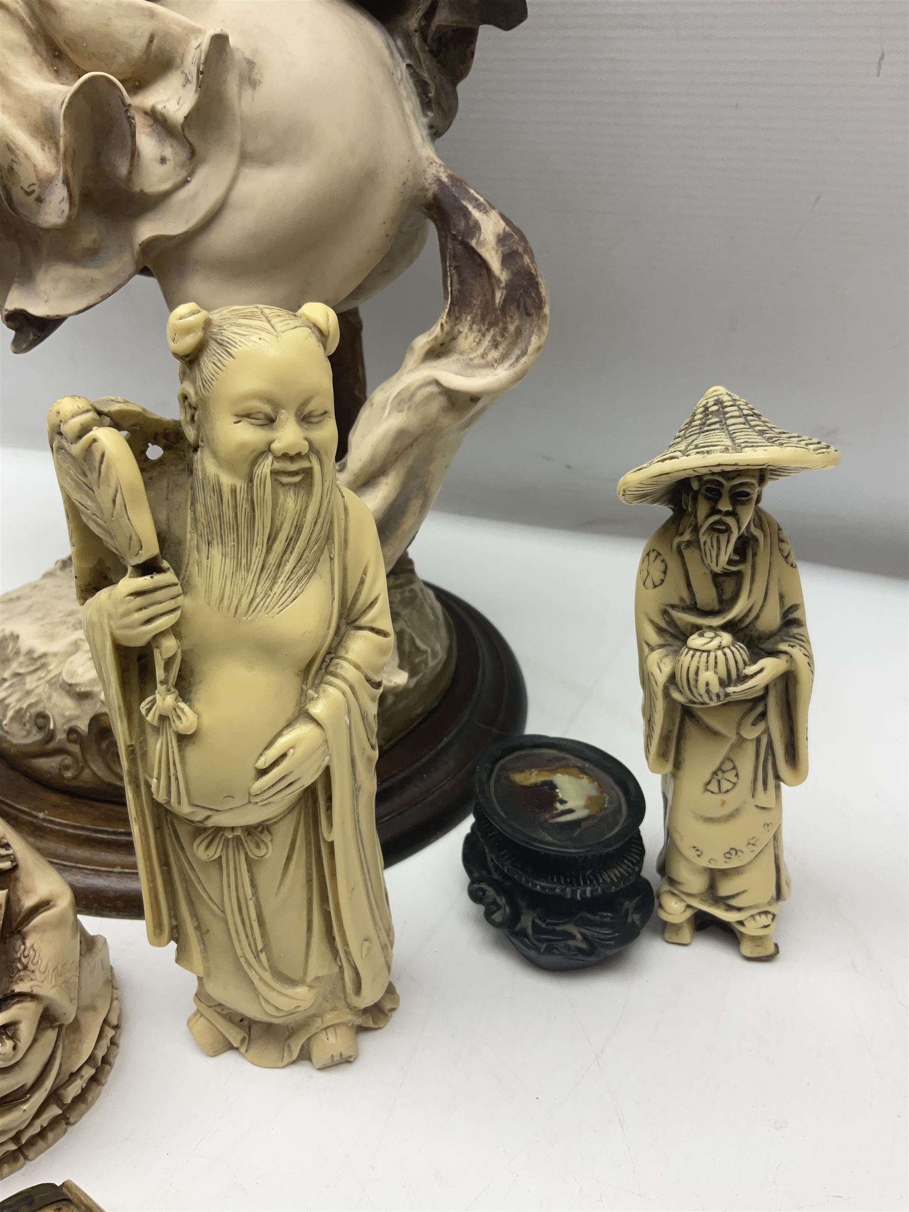 Composite figure of a couple upon a rearing horse, together with a collection of resin immortals and two bone chests 