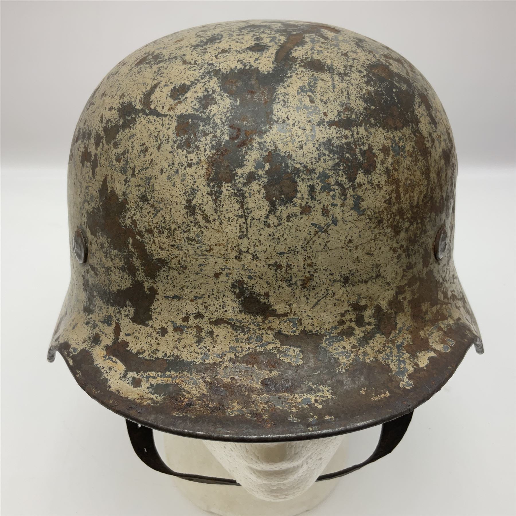 WW2 German Infantry M40 steel helmet with tropical finish and traces of single decal; with chin strap and leather liner marked 57 twice in red; back apron stamped 11 38