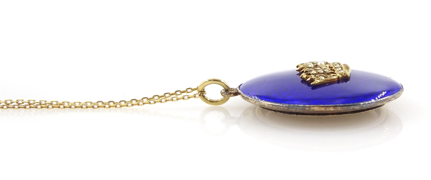 Early 20th century gold blue enamel pendant, with applied seed pearl Navel crown decoration, with glazed back, stamped 9ct, on later 9ct gold chain necklace, stamped 375