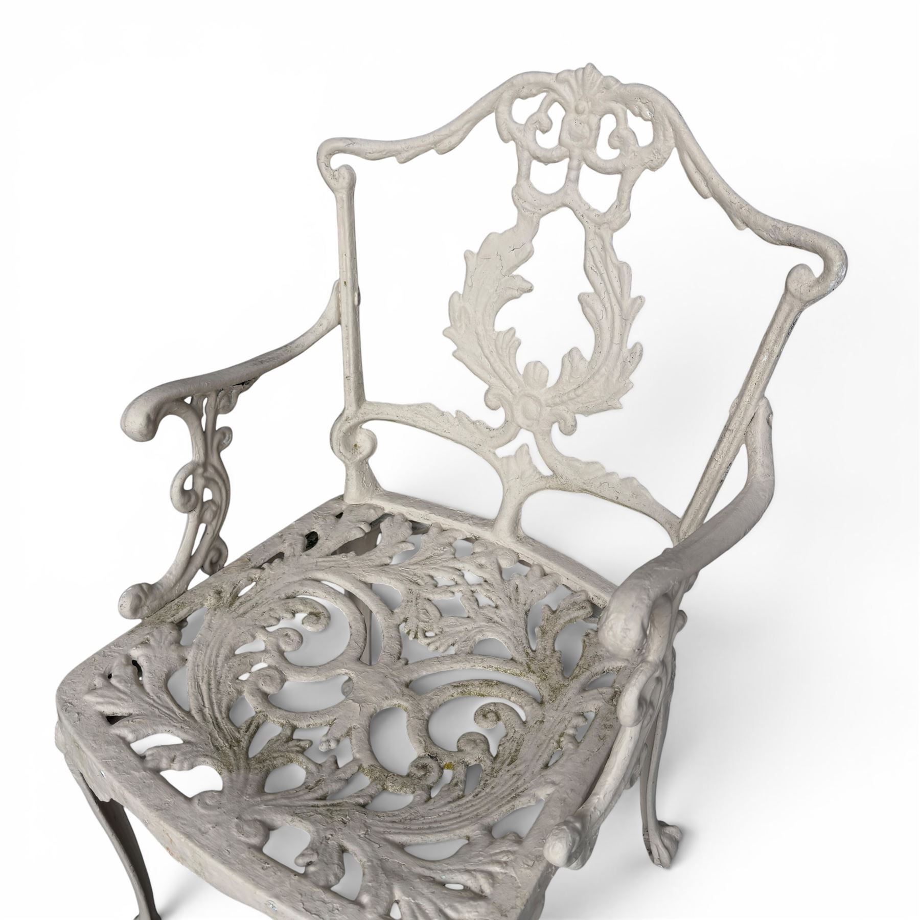Victorian design cast aluminium garden table and twin armchairs featuring a pierced floral wreath splat, over a stylised scrolling acanthus leaf seat, including parasol