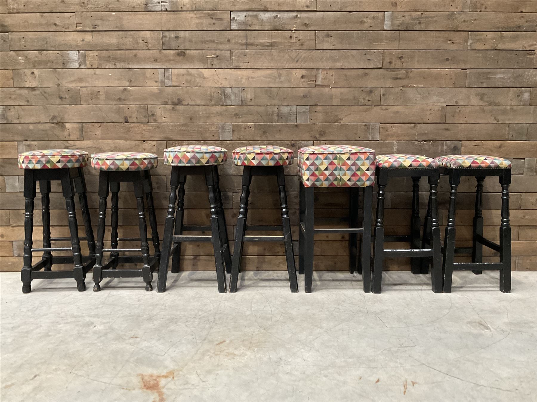 Seven tall bar stools with upholstered seat