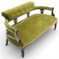 Late 19th century upholstered settee, shaped padded back with a row of button detailing, downswept open arms with upholstered pads, upholstered in olive green velvet, the frame with moulded rails and raised on turned front supports and out-swept rear legs with castors