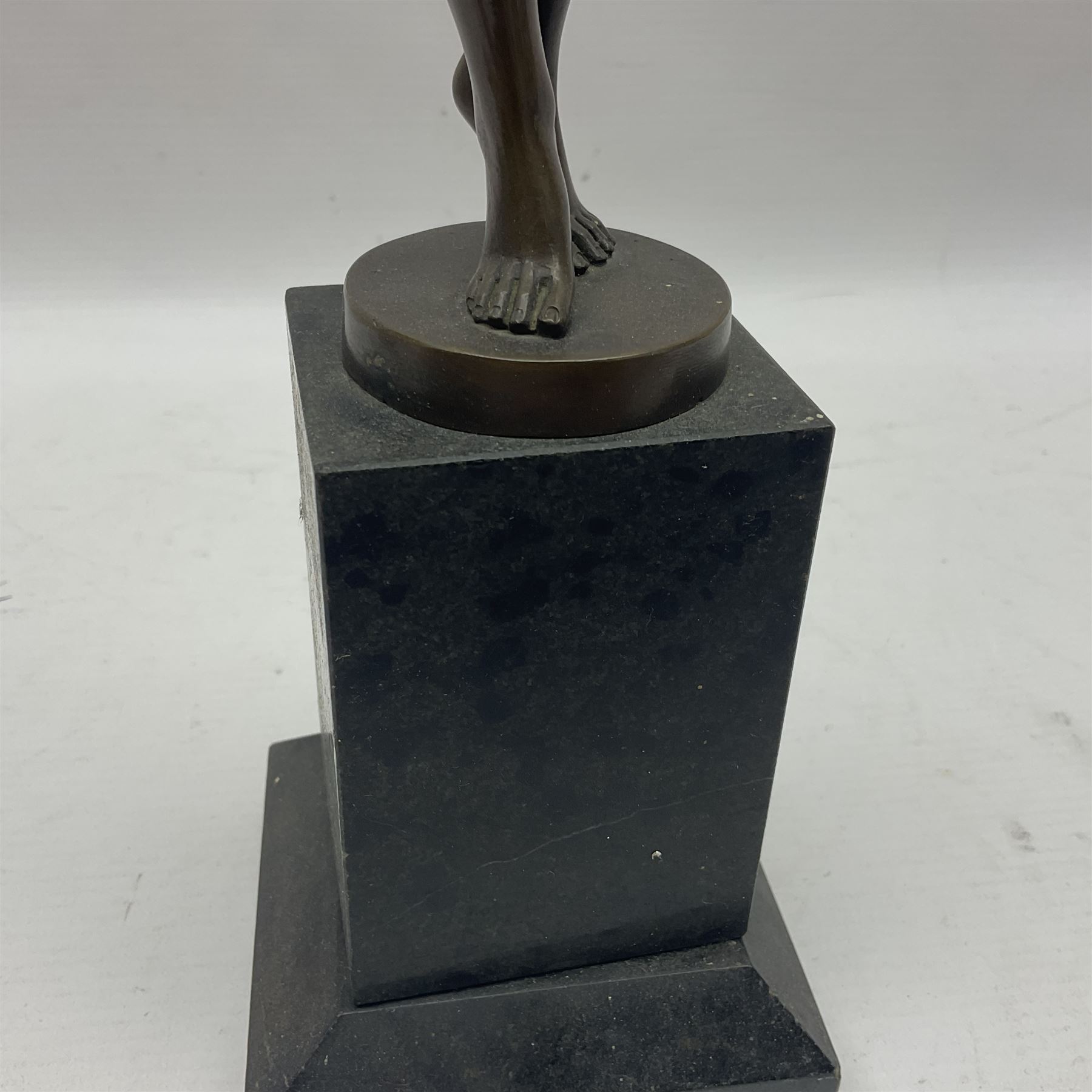 Bronzed semi nude female figure with one hand raised, upon a marble plinth, H43cm  