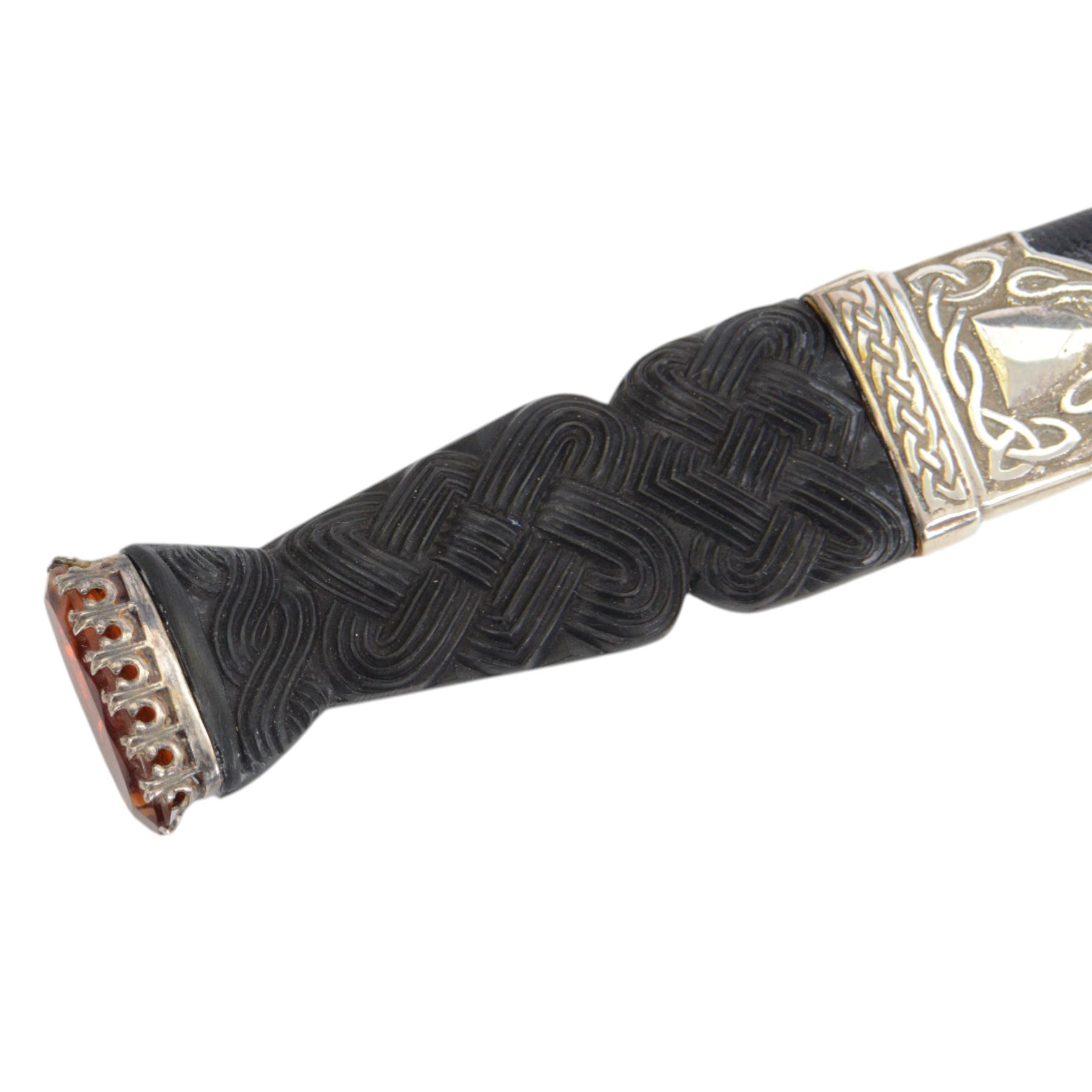 Skean dhu, the 9cm blade with scalloped back edge, with ebonised hilt and stone pommel, in its leather covered sheath with silver collar, hallmarked 1955