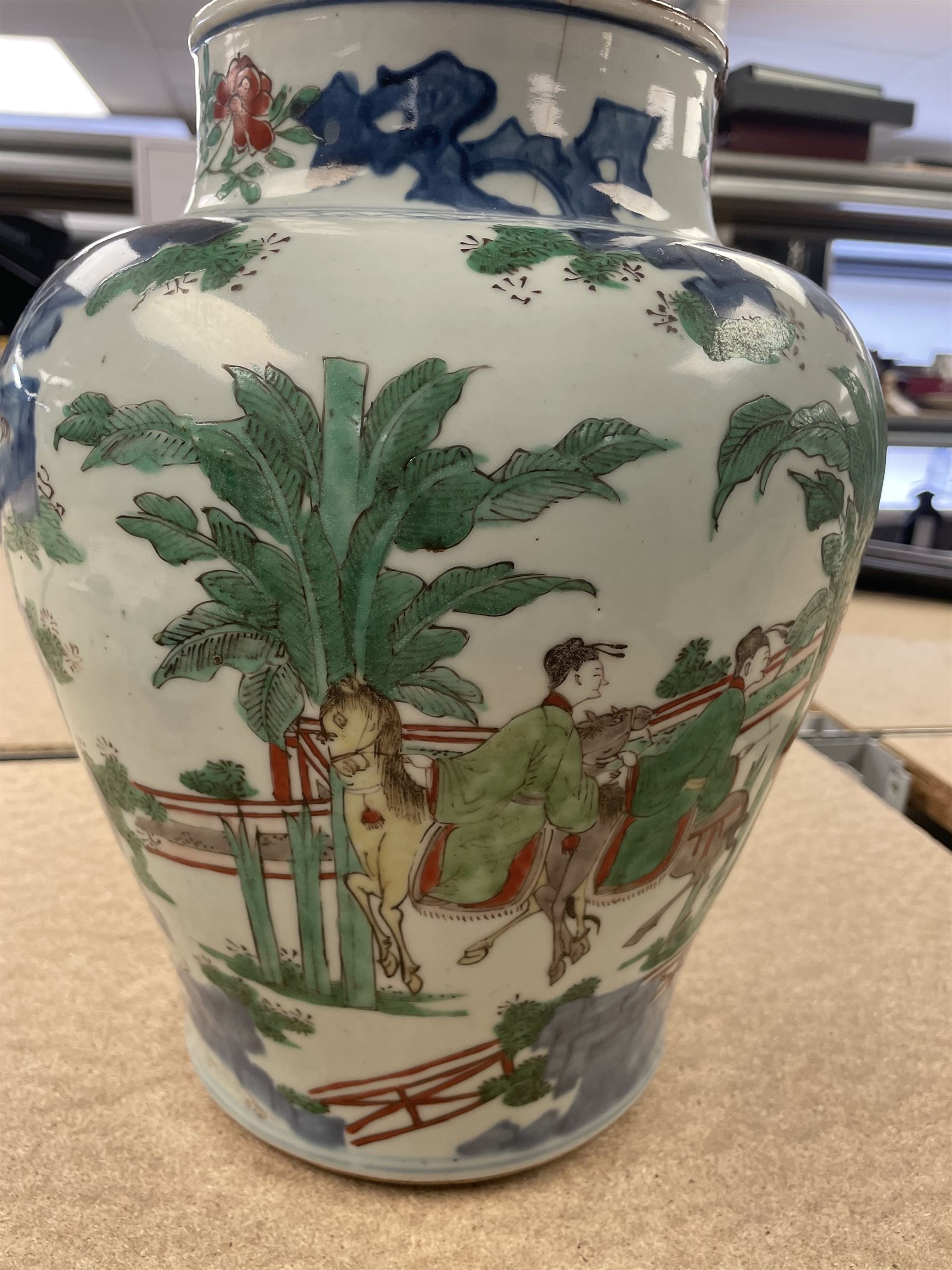 17th century Transitional period Chinese Wucai vase and cover, of baluster form, the body painted with ladies upon a terrace, and figures upon horseback and attendants within a fenced garden, the domed cover with knop finial painted with boys at play, H37cm

