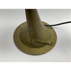 Arts & Crafts Jesson, Birkett & Co, brass table lamp or wall light, designed by Thomas Birkett, the tapering stem with adjustable ball pivot supporting a conical shade with tapering final with ball terminal, upon a circular domed base pierced for wall mounting, shade positioned upright overall H57cm

Often misattributed to Arthur Stansfield Dixon for Birmingham Guild of Handicraft, this particular lamp was designed by Thomas Birkett.
In the late 1890's Birkett worked as a metalwork at the Birmingham Guild, before later joining the Faulkner Bronze Company which went on to become Jesson, Birkett & Co in 1904. The lamp features in lighting catalogues from the firm under the model no E490.

