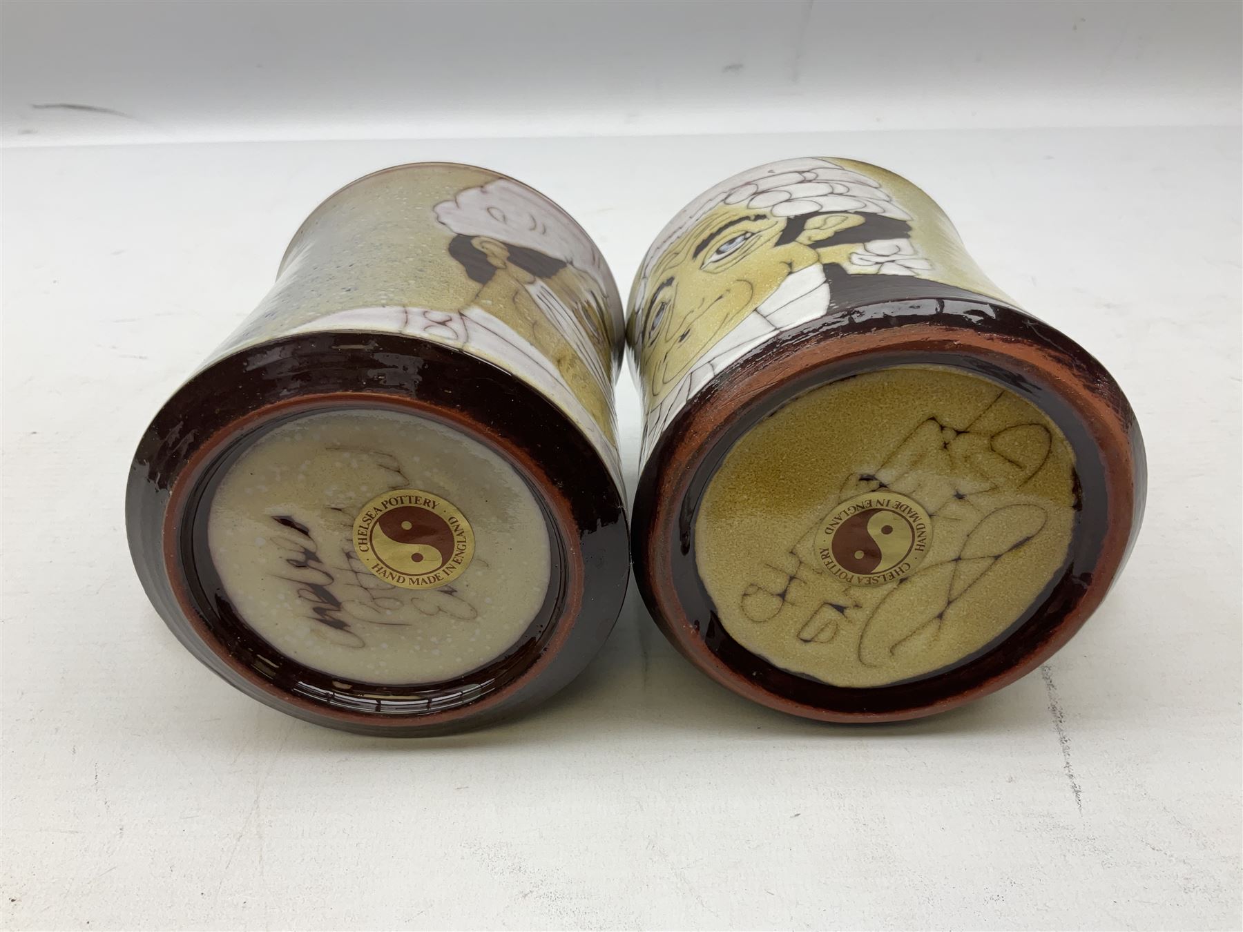 1960s Chelsea Pottery mug decorated with barrister by Joyce Morgan, signed JEM, together with a similar example depicting a doctor, H11.5cm, both signed beneath