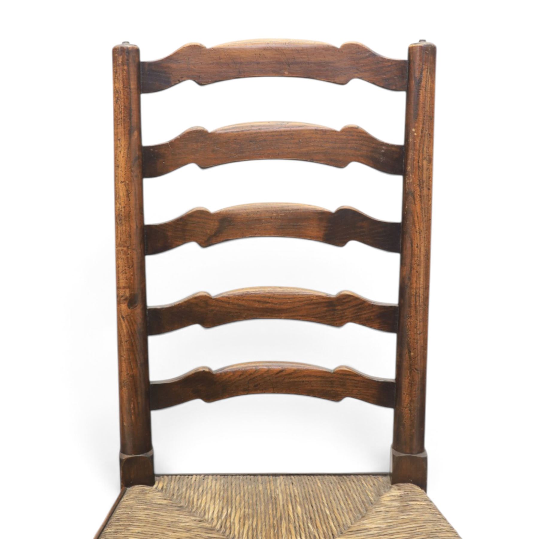 19th century set of six ash and elm ladderback dining chairs, shaped ladder backs above rush seats, raised on turned front supports with pad feet, united by turned stretchers