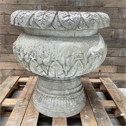 Large cast stone centrepiece urn planter, carved leaf rim and body, on circular plinth