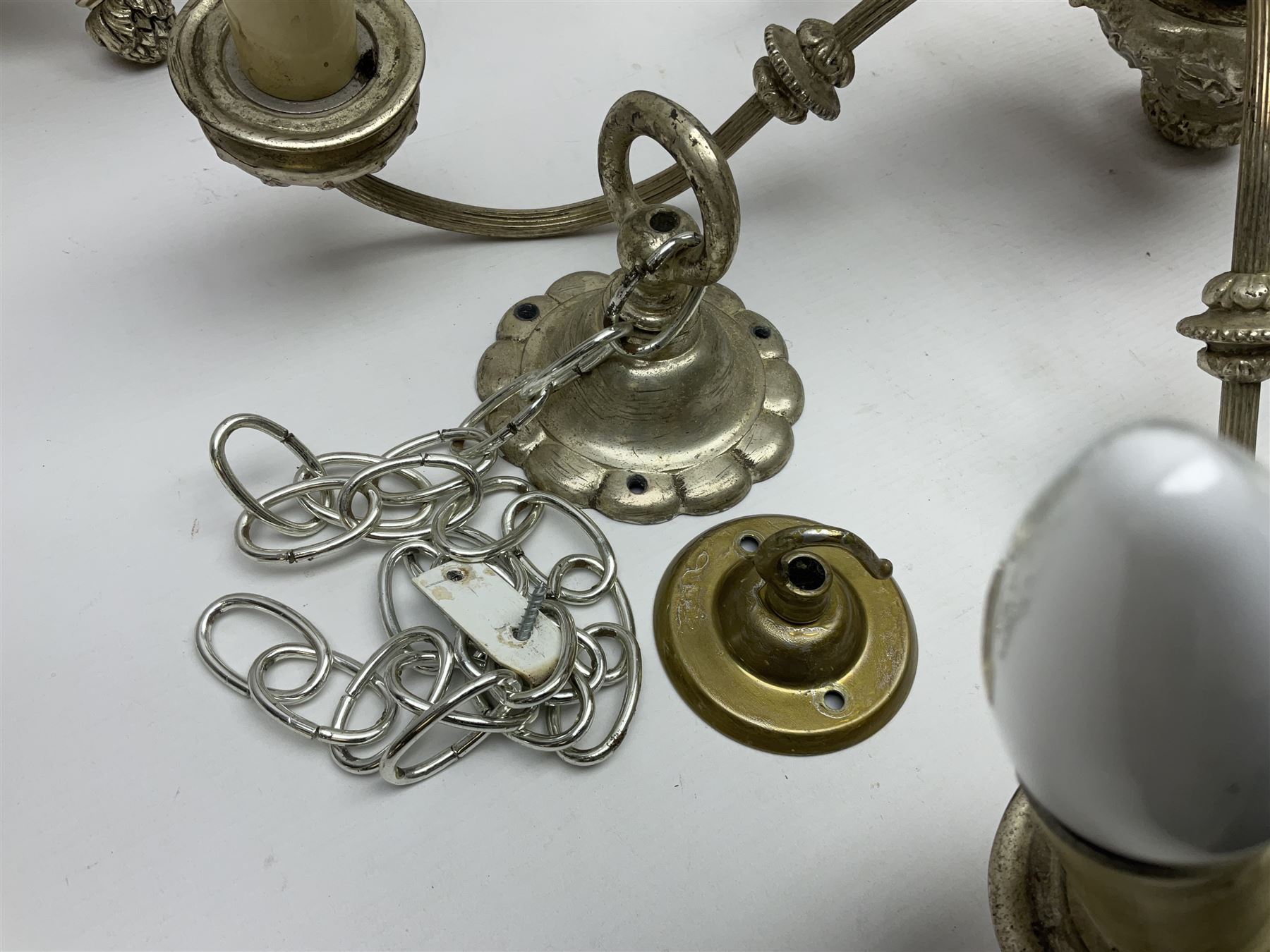 Siz branch silvered chandelier, decorated with acanthus leaves and putti, together with two matching three branch wall sconces, chandelier D65cm