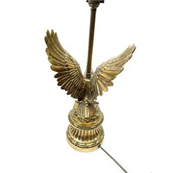 A brass table lamp modelled in the form of an eagle upon a circular base, overall H73cm.