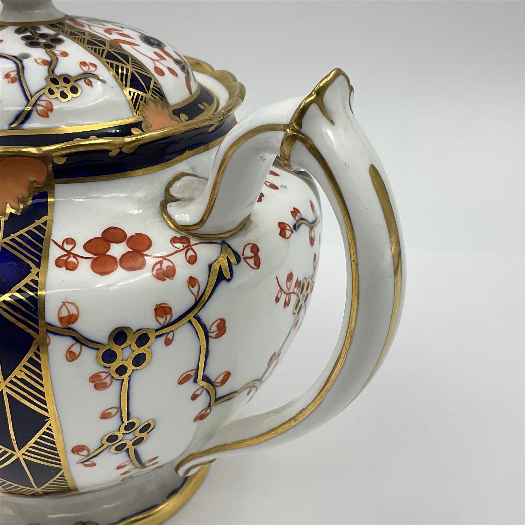 Early 20th century Royal Crown Derby teapot, decorated in a variant of the Imari pattern with blue and red prunus blossoms, with printed mark beneath including illustration date code for 1927, H14cm
