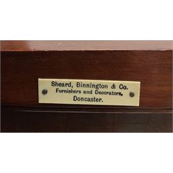 Edwardian inlaid mahogany display cabinet with ‘Shepard, Bennington & Co. Doncaster’ makers plaque, central bevel edge mirror flanked by two glazed doors enclosing two lined shelves, single drawer above cupboard on square tapering supports with spade feet