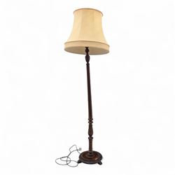 20th century mahogany floor lamp, the reeded column with carved urn knop on circular foliate moulded base, with cream fabric shade