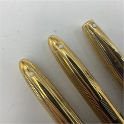 Sheaffer Crest fountain pen, the black barrel with gold plated cap and 18K nib, together with a matching ballpoint pen and further fountain pen, longest L14cm (3)