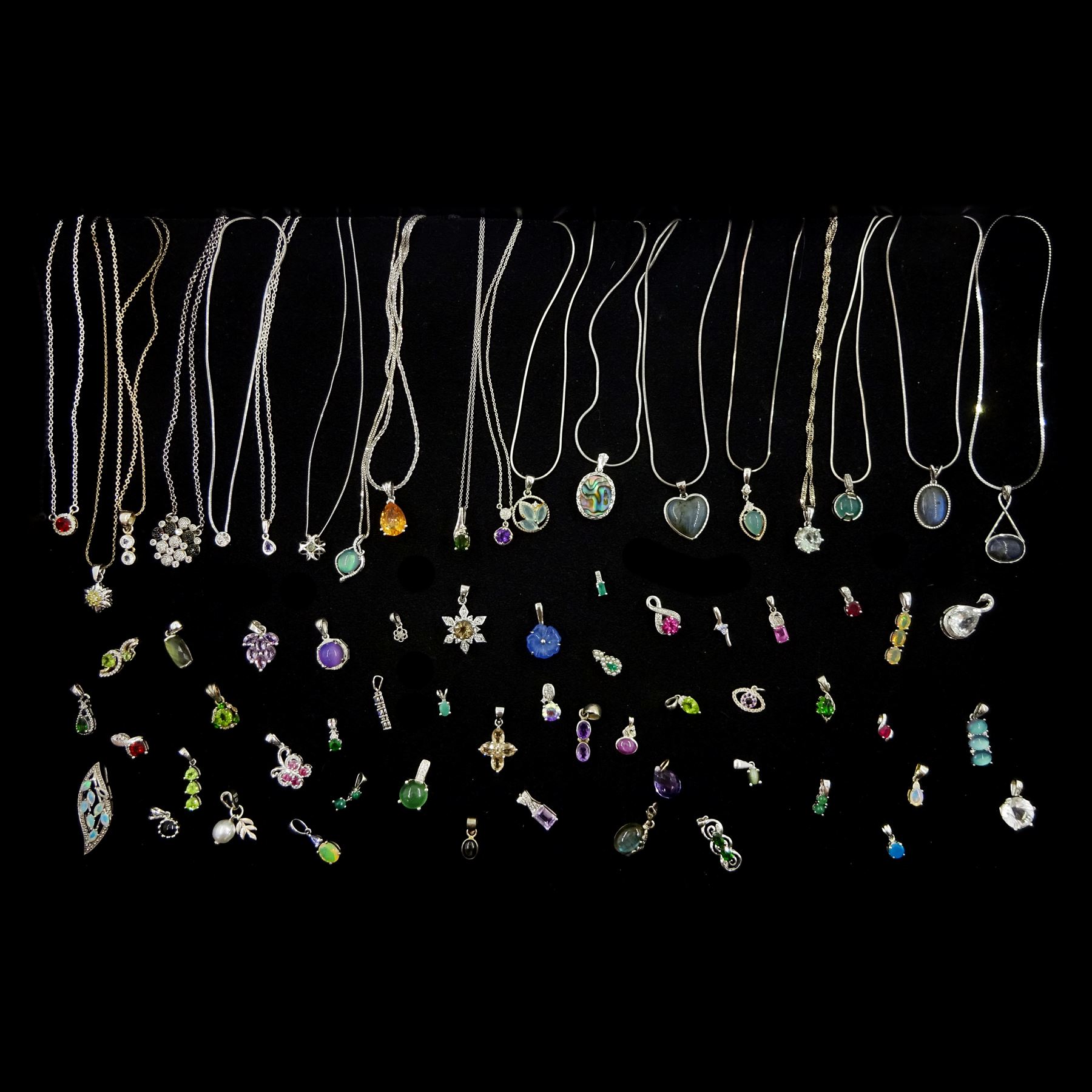 Nineteen silver stone set pendant necklaces including labradorite, amethyst, garnet and tanzanite and a collection of silver stone set pendants including pearl, peridot, opal, emerald, topaz, ruby and quartz