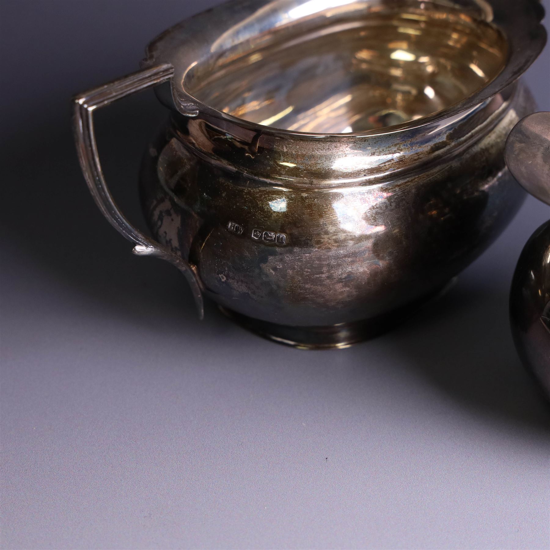 1930s three piece silver tea service, comprising teapot with wooden handle and finial, open sucrier and milk jug, hallmarked Viners Ltd, Sheffield 1930