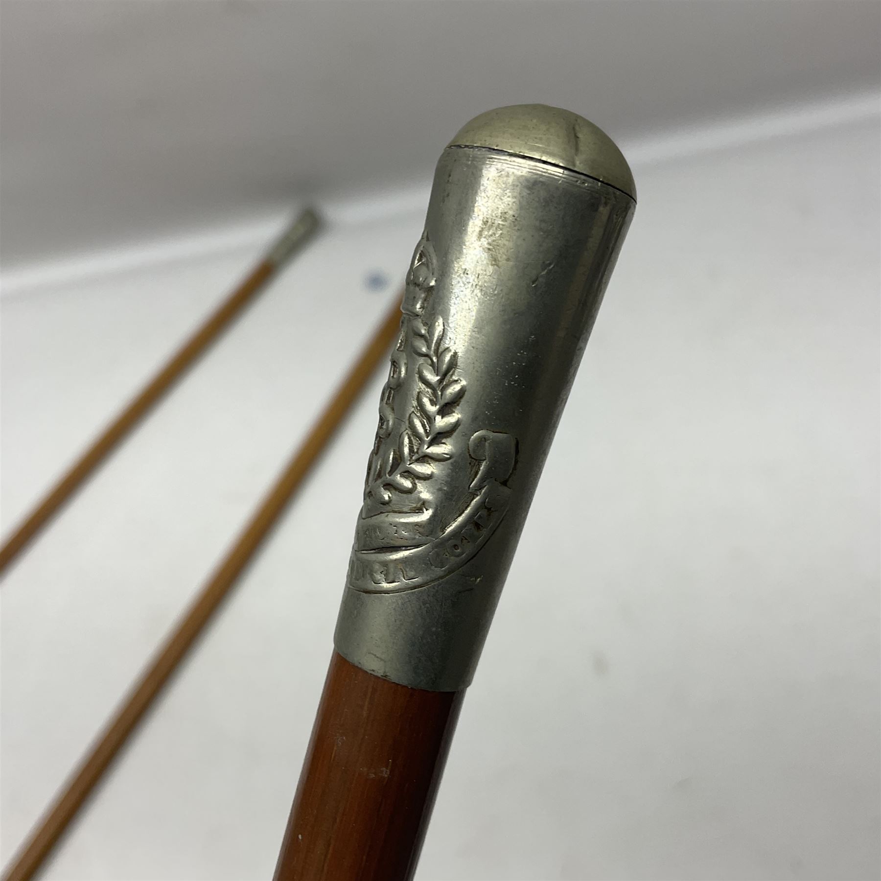 Three malacca cane swagger sticks - Duke of York's Royal military School L68cm; RAMC; and another embossed with a lion to the terminal (3)