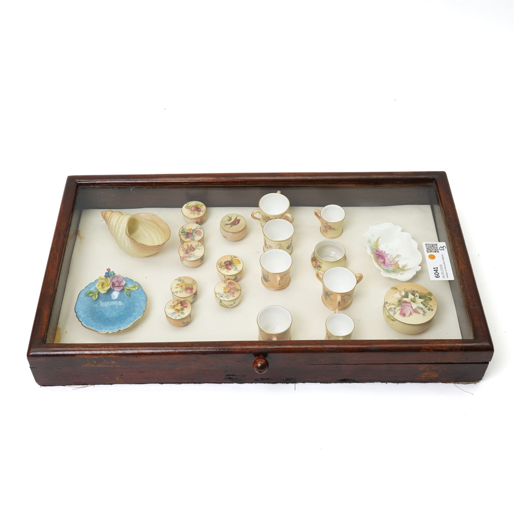 Large collection of miniature Royal Worcester hand-painted blush ivory wares, including shell shaped dish, and various covered trinket dishes, in glazed display case