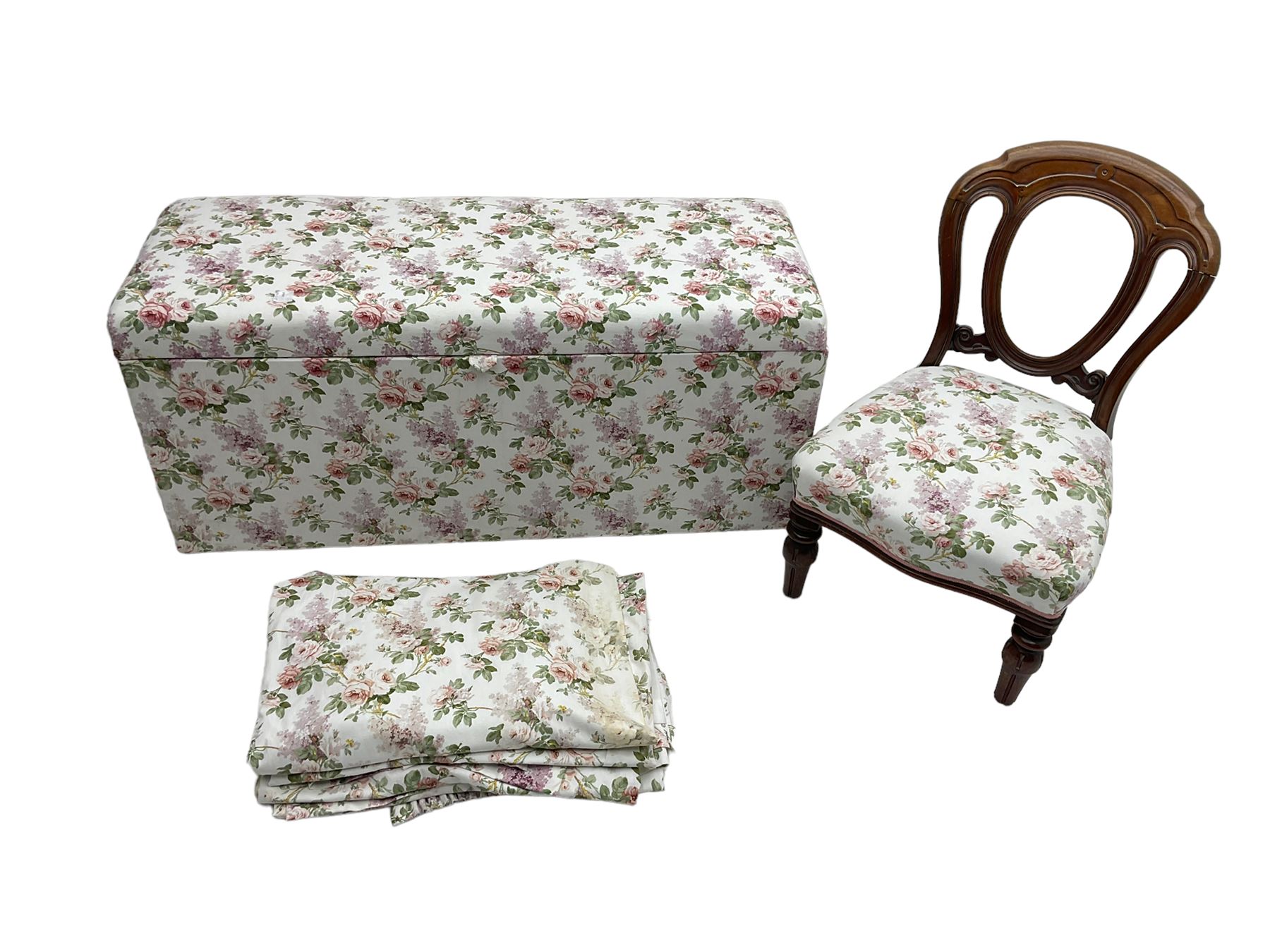 Ottoman blanket box upholstered in floral pattern fabric, matching bedroom chair and curtains