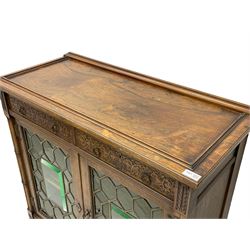 Edwardian rosewood display cabinet, rectangular top over two drawers with blind fretwork facias, enclosed by two doors with lead glazed and bevelled panels, turned half column pilasters terminating into cluster column supports, united by undertier with raised fretwork gallery, on turned feet