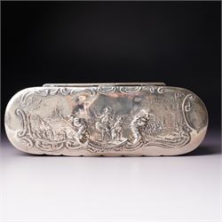 19th century continental silver box of oval design , the hinged cover with swing handle embossed with sailing ships, castle etc, the base decorated with horse and cart in rural landscape and the sides with a hunting scene on ball feet L15cm