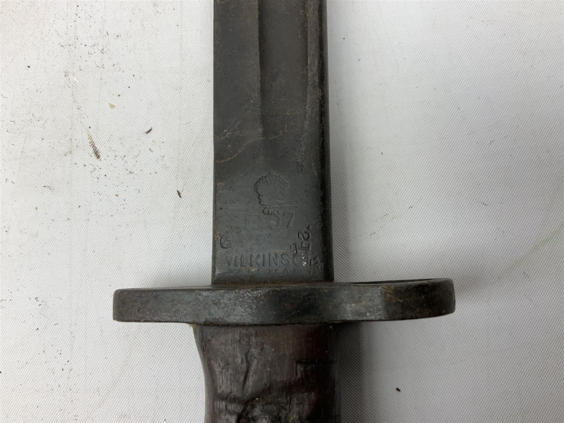 British Pattern 1907 bayonet with 43.5cm fullered steel blade; in leather scabbard with webbing frog L58cm overall; another Pattern 1907 bayonet lacking scabbard; and British Pattern 1888 Mk.I bayonet by Wilkinson London (no scabbard) (3)
