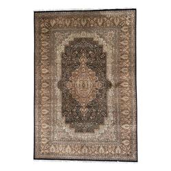Large Persian indigo ground rug, the busy field decorated with trailing branches and flowe...