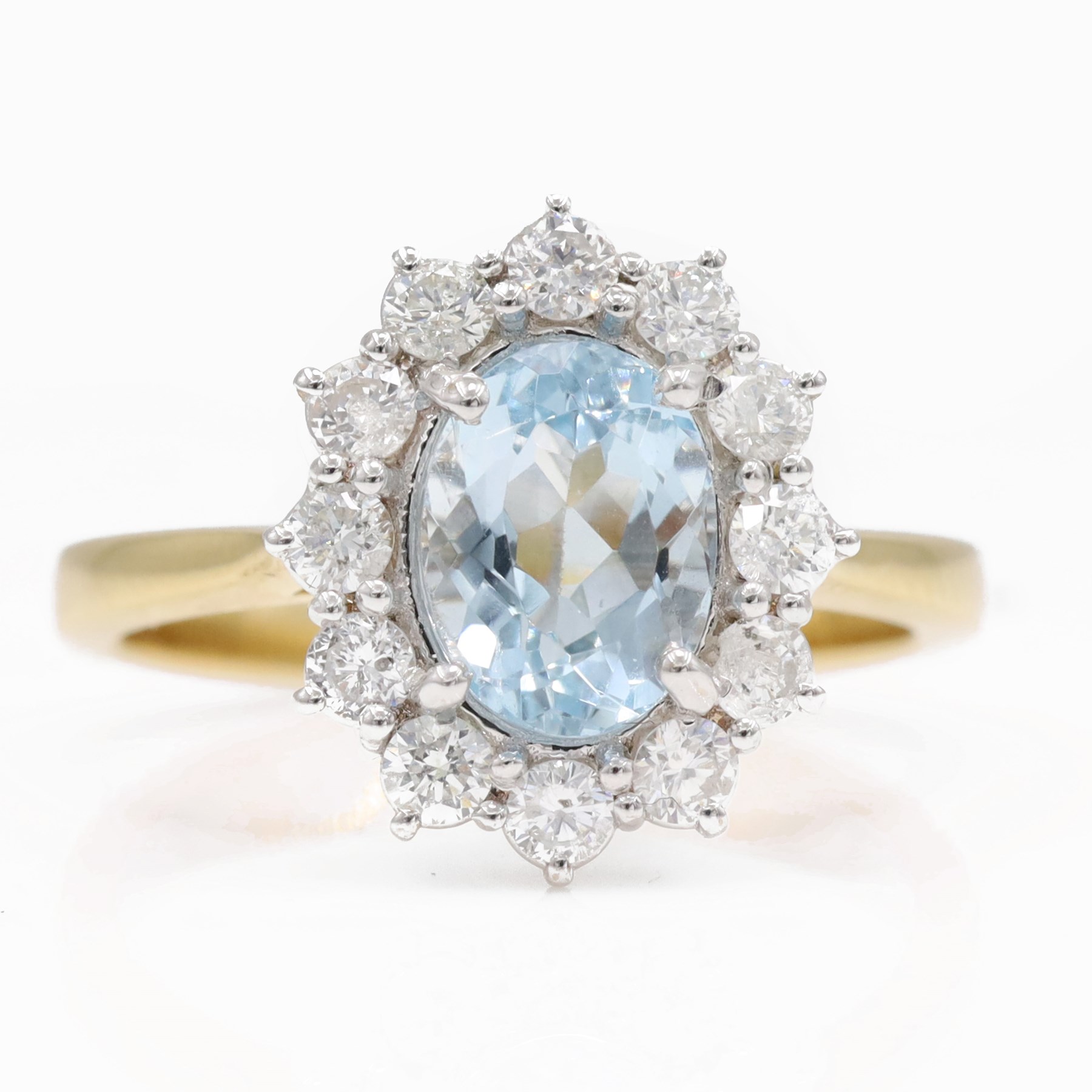 18ct gold aquamarine and diamond cluster ring, single oval cut aquamarine of approx 1.25 carat, surrounded by twelve round brilliant cut diamonds, hallmarked, total diamond weight approx 0.30 carat