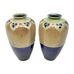 Pair of Royal Doulton Lambeth stoneware baluster vases, decorated in light relief with foliage, impressed mark beneath, H23cm