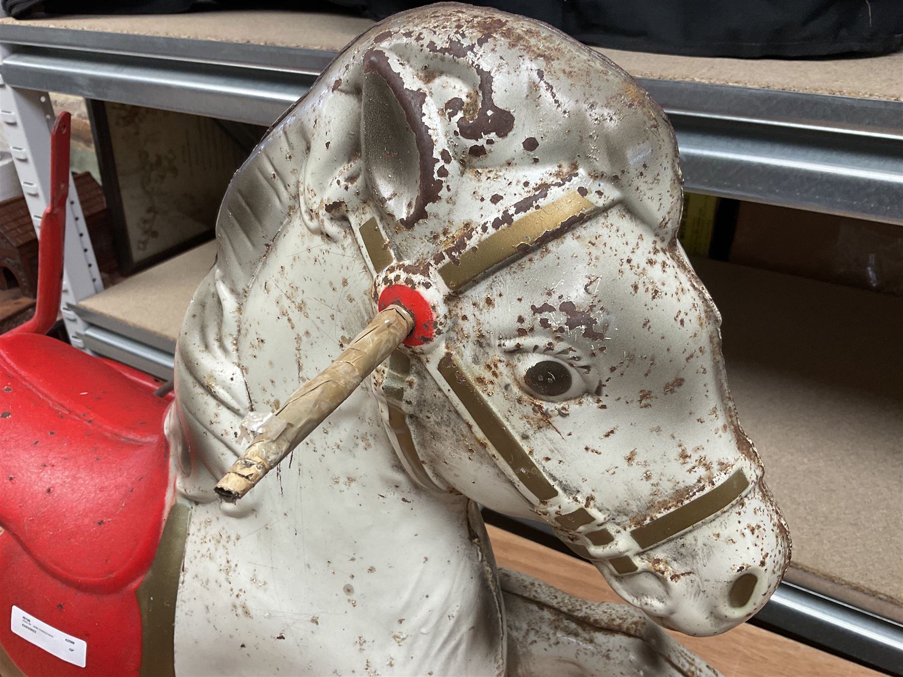 1960's Mobo Toys (David Sebel & Co) Prairie King spring rocking horse on stand, painted pressed steel construction, red tubular stand, trademark red and yellow circular Mobo logo, 100cm long (dismantled)