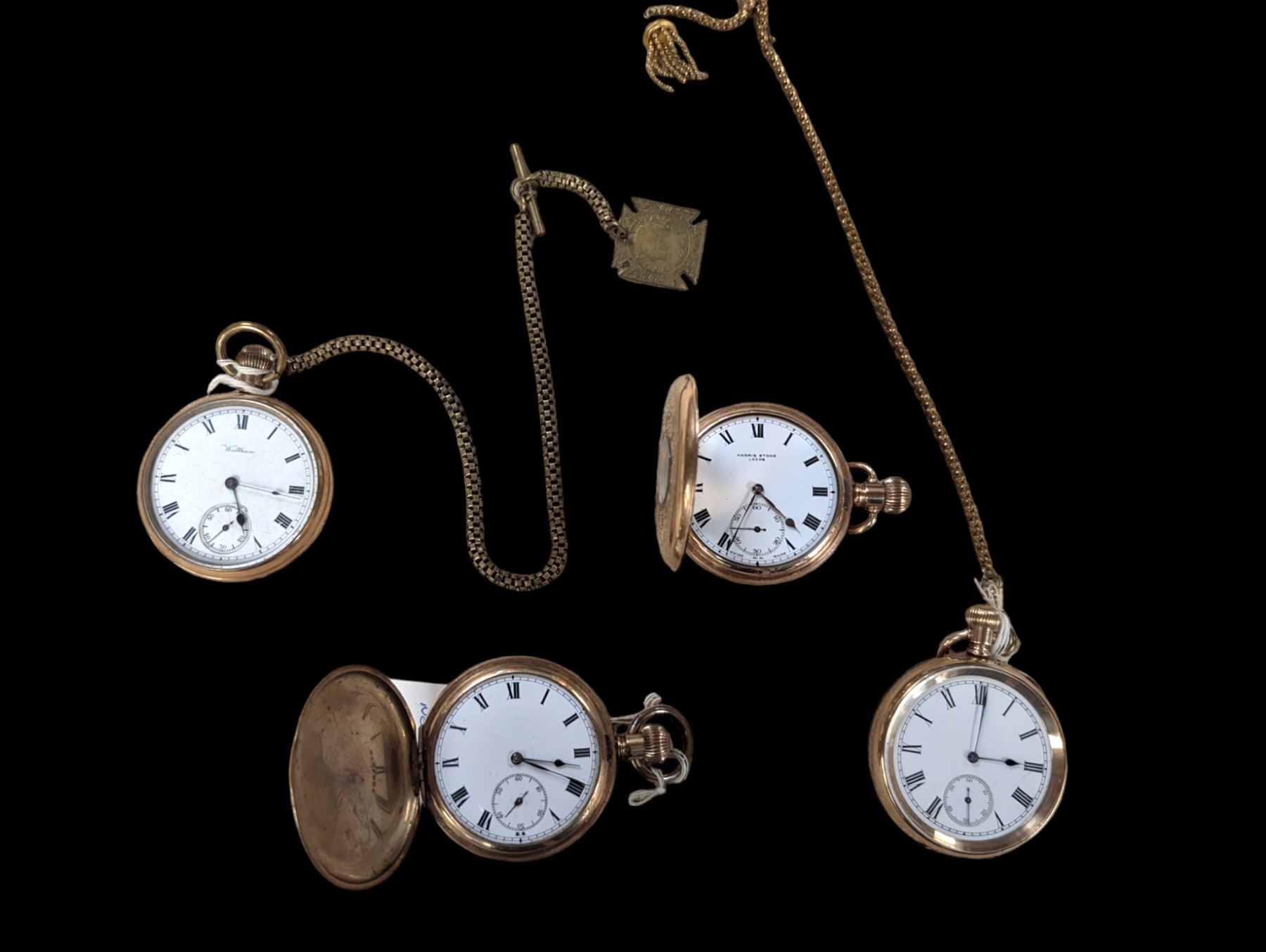 Four early 20th century gold-plated keyless pocket watches, three by Harris Stone Leeds, Waltham and Elgin and two gold-plated watch chains