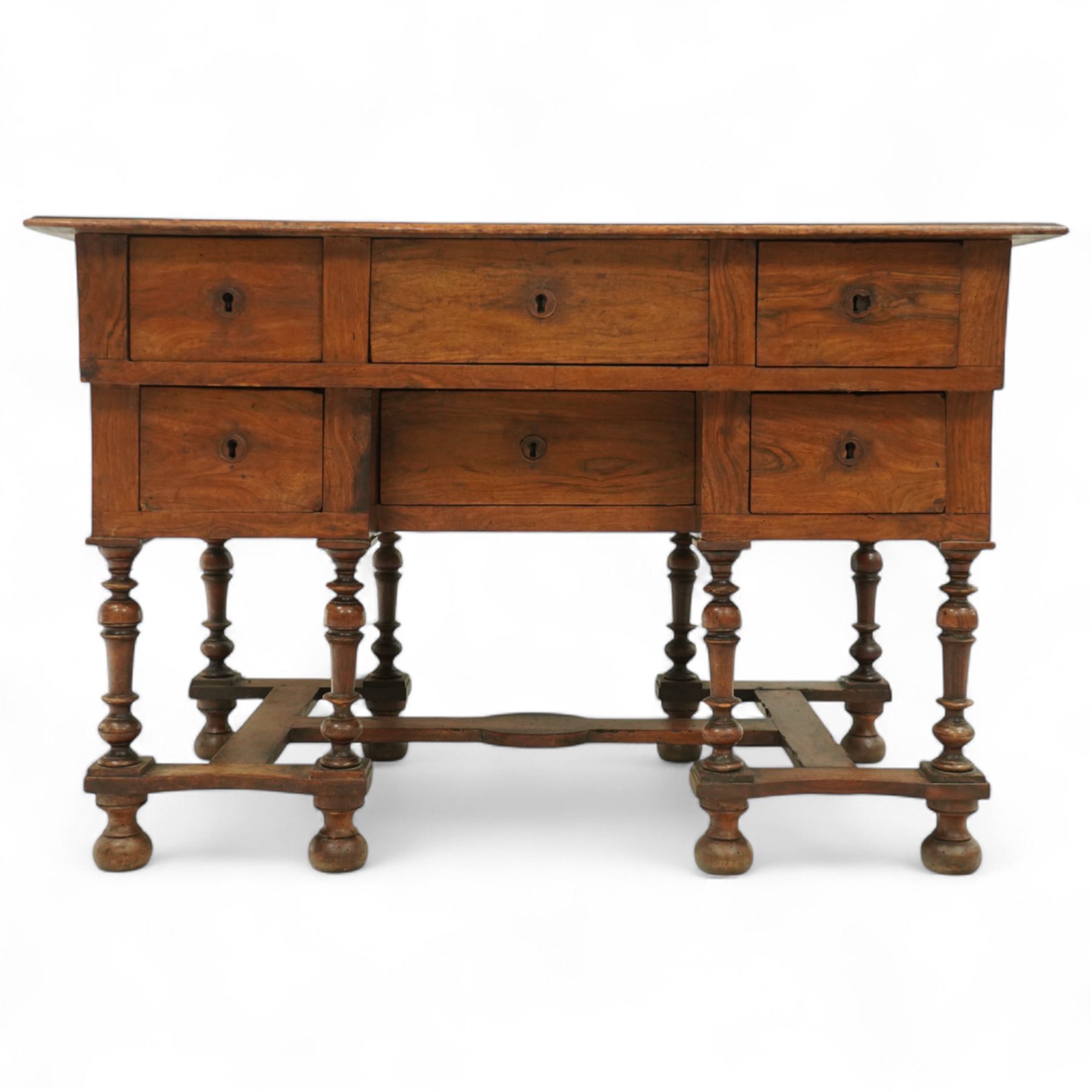 19th-century Louis XIV design French walnut bureau Mazarin, rectangular top above central drawer and recessed drawer flanked by two rows of small drawers,  supported on baluster turned legs united by an H-form stretcher, raised on bun feet 