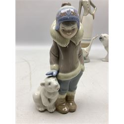 Seven Lladro figures, comprising Playful Puppy no 9135, Platero and Marcelino/Boy Hugging Donkey no 1181, Mini Seal Family no 5318, Attentive Polar Bear no 1207, Seated Polar Bear no1209, Eskimo Boy with Pet no 5238 and Girl with Geese no 1035, together with Nao goose