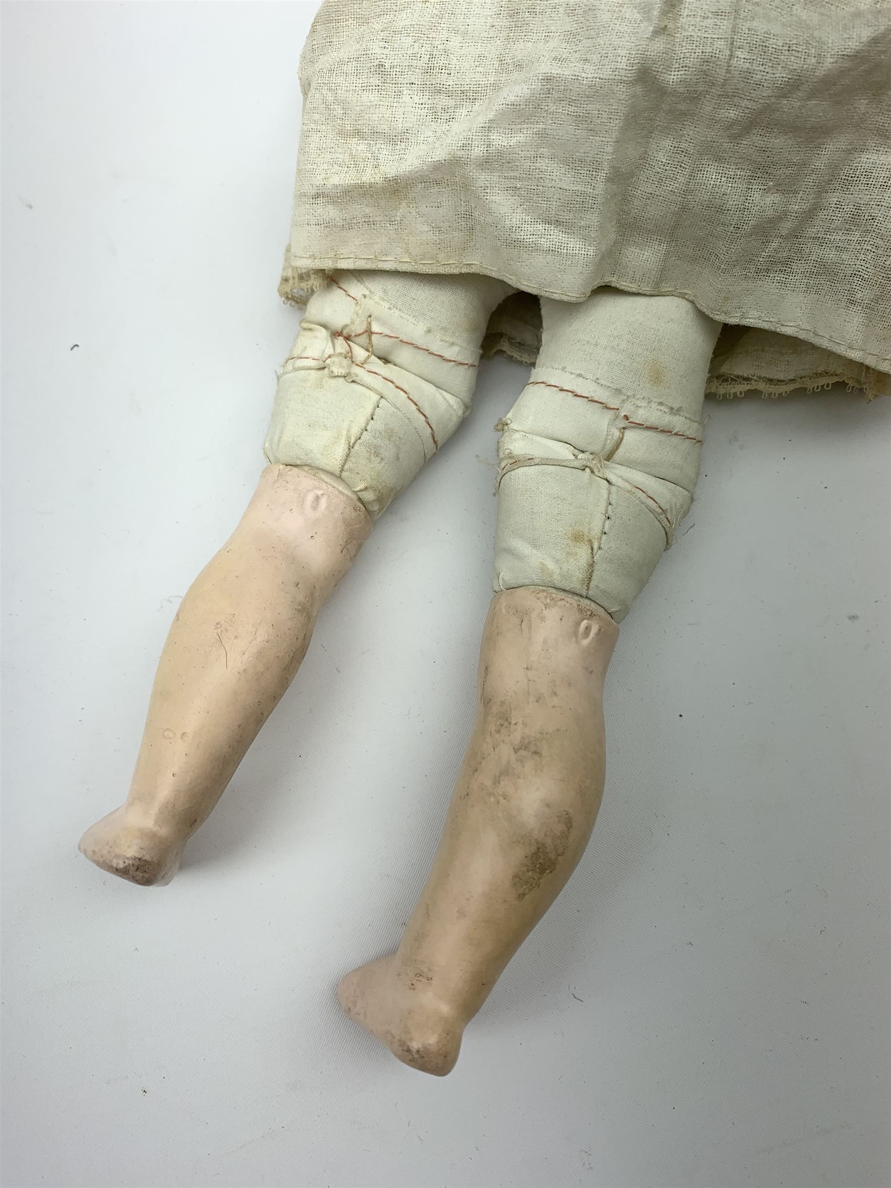 Early 20th century Cuno and Otto Dressel wax shoulder head doll with applied hair and fixed glass eyes, soft body with jointed composition lower limbs, maker's stamp to right thigh, clothing and box H38cm in original box